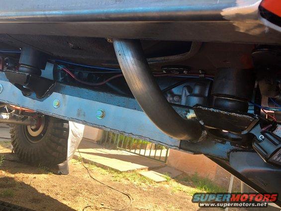 close-up of suspension and exhaust system on a lifted vehicle