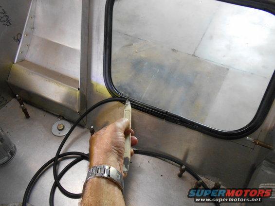 Hand installing rubber seal around a vehicle window frame