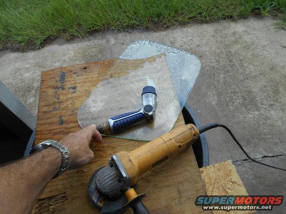 Angle grinder and glass cutter on a piece of glass