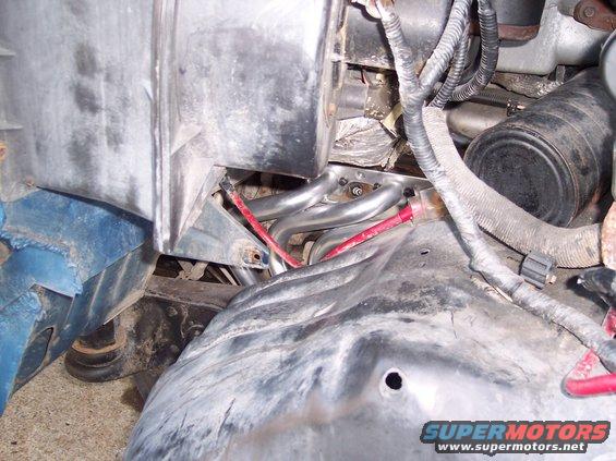engine bay showing exhaust headers and wiring
