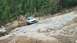 1995 Ford Bronco - White Ford F-150 truck carefully maneuvers over a challenging rocky terrain on an off-road trail.