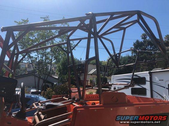 Custom roll cage structure over orange vehicle interior