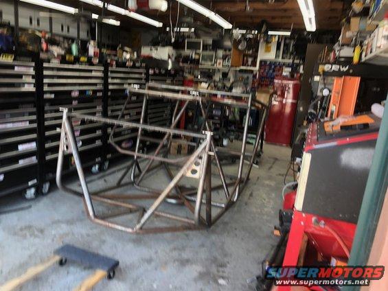 Roll cage frame in garage with tool chests and equipment