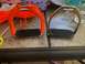 1992 Jeep Wrangler - Horse stirrups, one with orange paracord wrap, sit on a table next to scissors and cord.