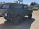 1978 Ford Bronco - This 1978 Ford Bronco is shown from a three-quarter front view, with a white pickup truck in the background.
