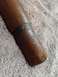 2003 Ford F-250 - Wooden handle with a metal band shows wear and a crack.