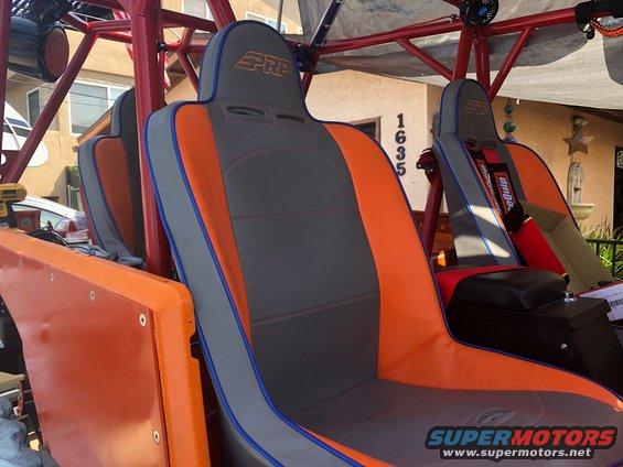Orange and gray PRP seats inside a custom off-road vehicle