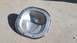 2005 Ford Mustang - A differential cover with a gasket is shown resting on a concrete surface.