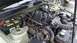2005 Ford Mustang - The engine bay of a 2005 Ford Mustang, showing the V8 engine, battery, and intake system.