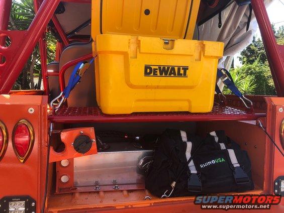 Orange off-road vehicle rear storage with yellow DeWalt cooler and black RhinoUSA bag