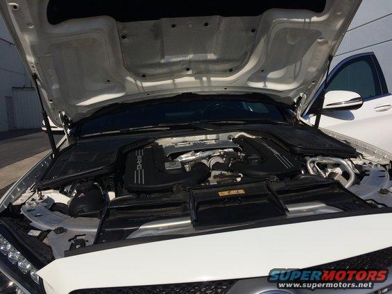 White 2017 Mercedes-Benz C-Class engine bay with hood open, showing the AMG engine