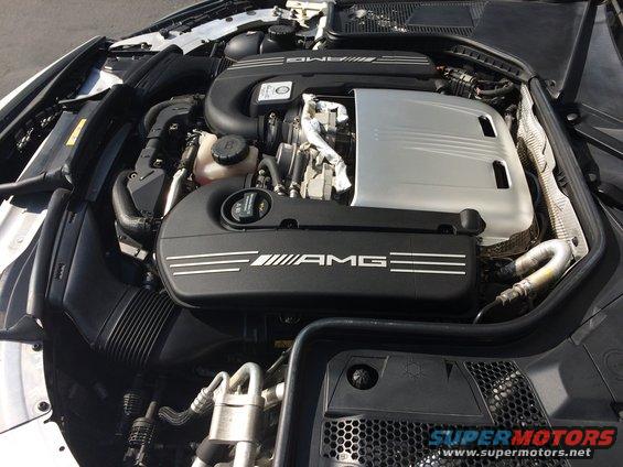 Engine bay with AMG branding on covers. Supermotors.net watermark visible