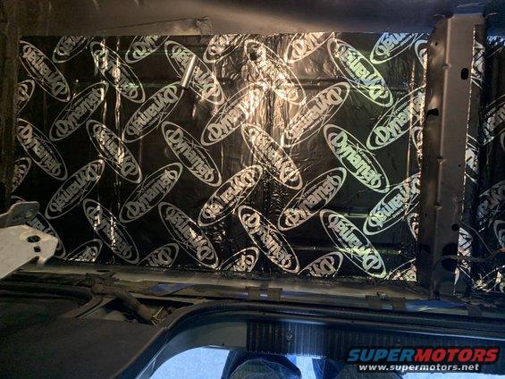 Car interior with Dynamat sound deadening applied to the ceiling panel. Some metal framing is visible on the right