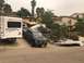1992 Jeep Wrangler - A black Ram pickup truck is parked in a driveway next to a recreational vehicle.