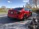 2009 Holden Commodore - Rear view of a red 2009 Pontiac G8 sedan on a dirt road.