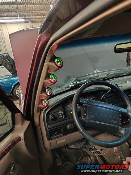 1996 Ford Bronco interior with four gauges on the A-pillar and a Ford steering wheel