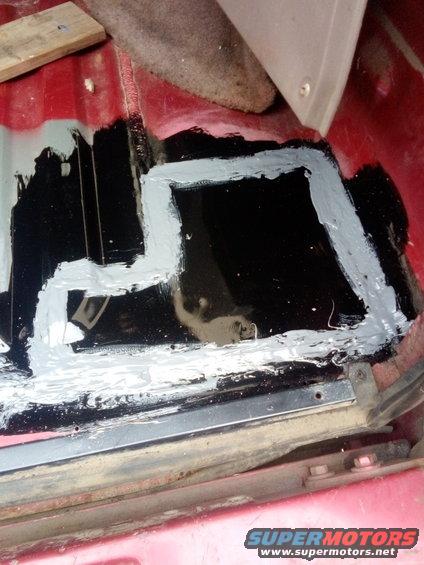 Vehicle floor with rust repair using black sealant and gray primer