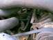 1988 Ford Bronco - Close-up view of engine components, including hoses and belts, in a vehicle's engine bay.