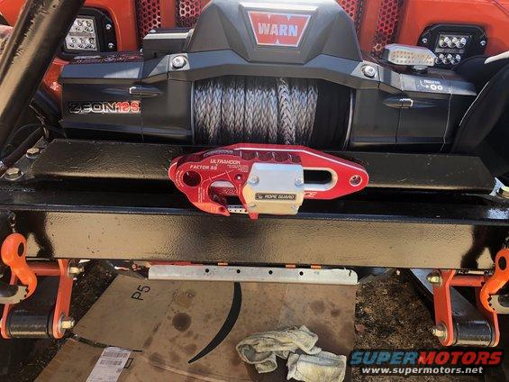 WARN Zeon 12S winch and UltraHook shackle on an orange Jeep Wrangler bumper.