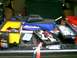 1988 Ford Bronco - The cargo area of a vehicle is filled with various tools and storage containers, including a yellow toolbox and an open red toolbox with wr…