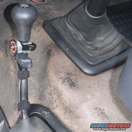 dscf2593--hand-throttle-shifter.jpg Hand throttle lever mounted to the transfer case shifter.  Rather than an adapter, I used a couple wraps of bicycle tire tube to snug it up to the t-case shifter's smaller diameter.