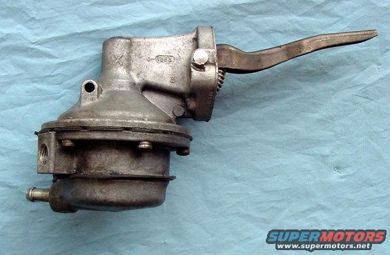 Mechanical fuel pump with metal lever arm, on blue cloth background