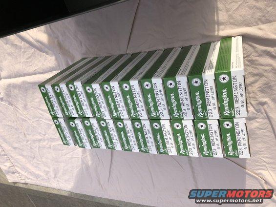 Stack of green and white boxes of Remington 223 ammunition