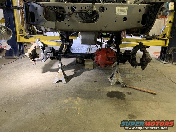 Jeep Cherokee front axle assembly on jack stands, with red ARB differential cover
