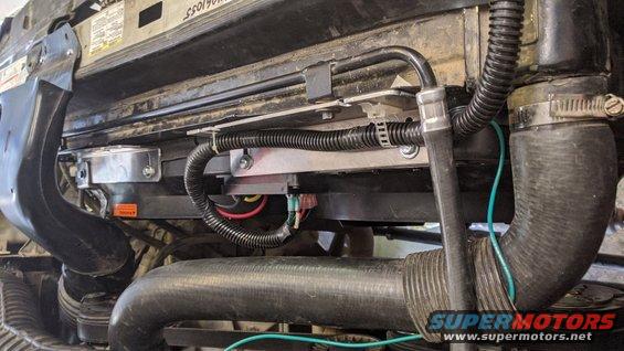 close-up of vehicle's engine cooling fan and radiator hoses