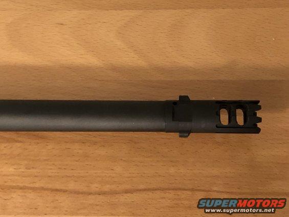 Black muzzle brake with dual oval ports and serrated teeth