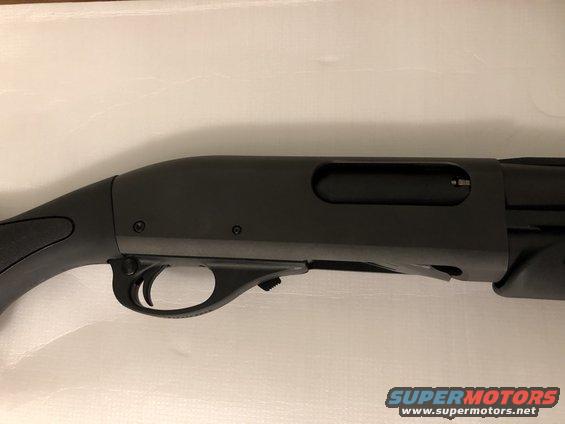 Close-up of a black shotgun receiver and trigger assembly