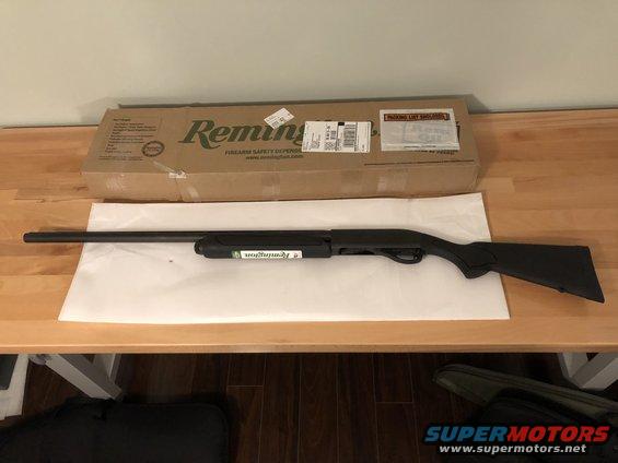 Remington shotgun with box on table