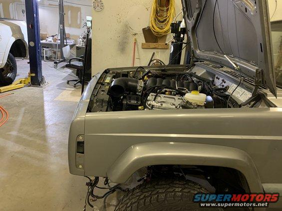 2000 Jeep Cherokee engine bay with hood open, showing engine components and wiring
