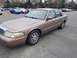 1995 Mercury Grand Marquis - This Mercury Grand Marquis sedan is a tan color and is parked in an outdoor lot.