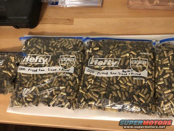 Bags of 9mm shell casings labeled '1000 Mixed 9mm Sized + Primed'