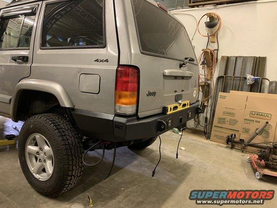 2000 Jeep Cherokee with aftermarket rear bumper installed, showing a yellow level on top