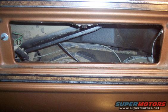 Copper-colored dashboard with an open cavity revealing heater core, ducting, and wires