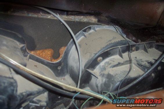 Heater blower motor housing with rust visible