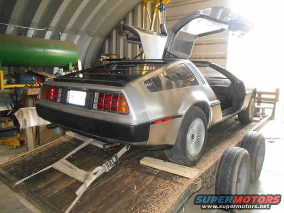 DeLorean DMC-12 on trailer, gullwing doors open