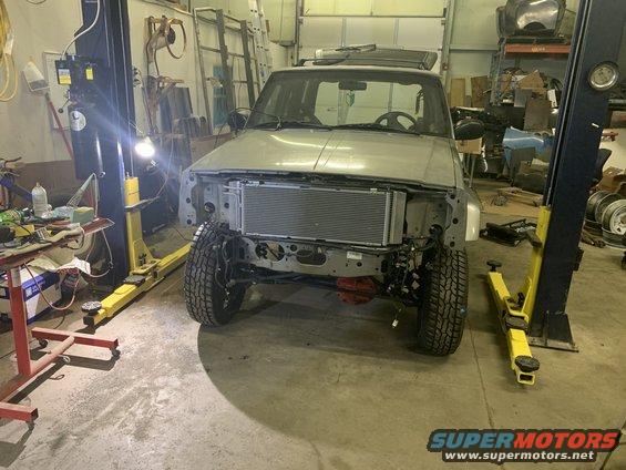 Silver 2000 Jeep Cherokee front end removed, showing new radiator
