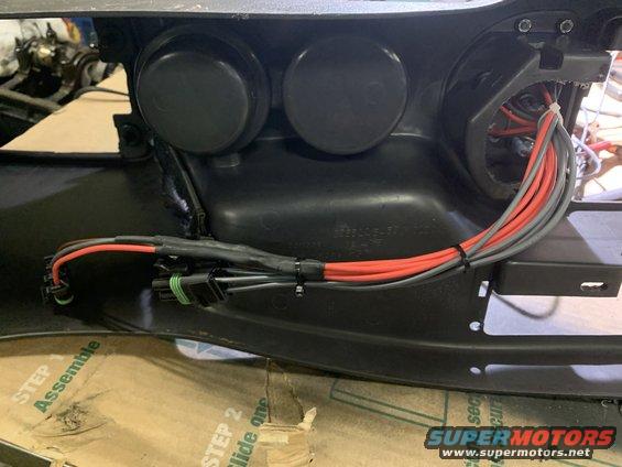 Wiring harness with red and gray wires connected to black plastic housing