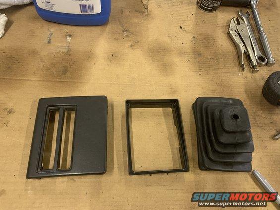 Jeep Cherokee shift boot, trim bezel, and inner frame on a workbench