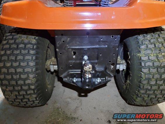 Rear view of a lawn tractor with a ball hitch attached to the frame