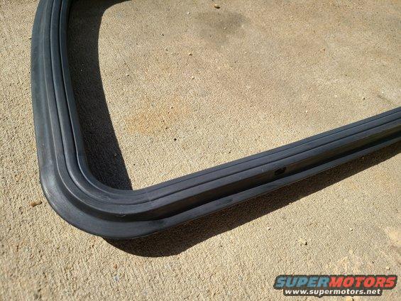 Rubber seal with multiple channels, lying on a concrete surface