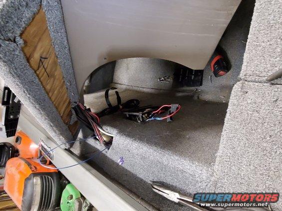 Boat interior showing exposed wiring and carpeted surfaces