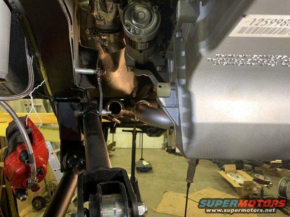 Undercarriage of a 2000 Jeep Cherokee showing exhaust and suspension components