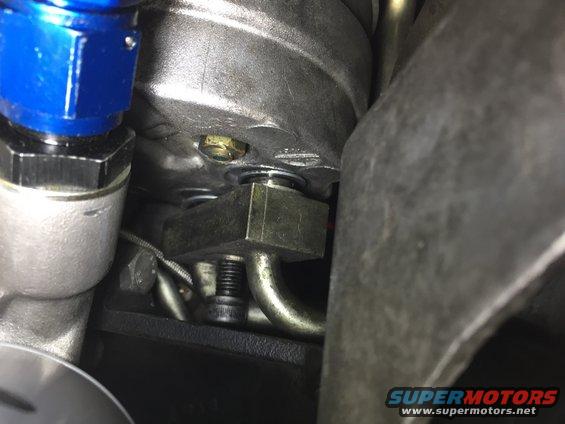 Close-up of engine component with blue fitting and metal tubing