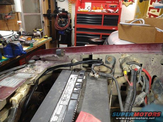 Engine bay wiring and battery. Red vehicle