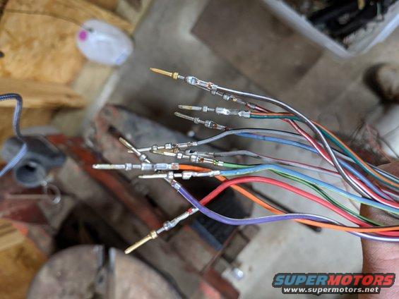 These are the wires I removed from C115 because they are not needed.  It's cleaner to remove them rather than cut them and I can put one back if I screw up and realize it was needed after all.  To remove them, remove the red separators with small needle nose pliers then use a tiny flathead screwdriver to gently pry the tab on each wire to be removed.