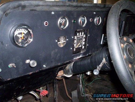 Dashboard with multiple gauges, including speedometer and fuel level. Steering wheel is visible